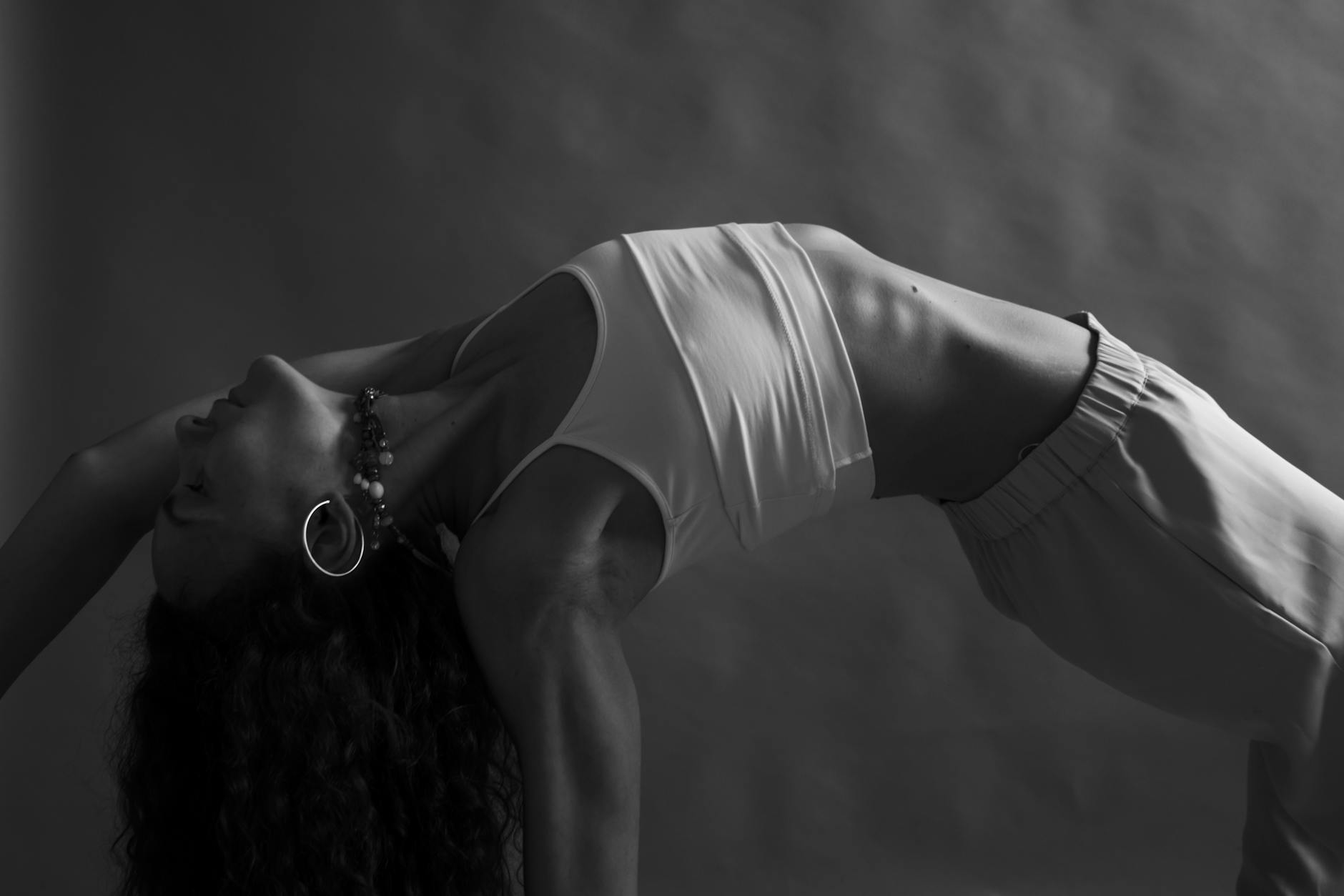 Silhouette of a person meditating at sunrise, focusing on breathing.